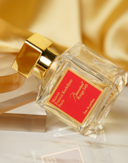 Baccarat Rouge 540 – Lifestyle Angle Maison Francis Kurkdjian Baccarat Rouge 540 Eau de Parfum 70ml bottle on a warm satin background
